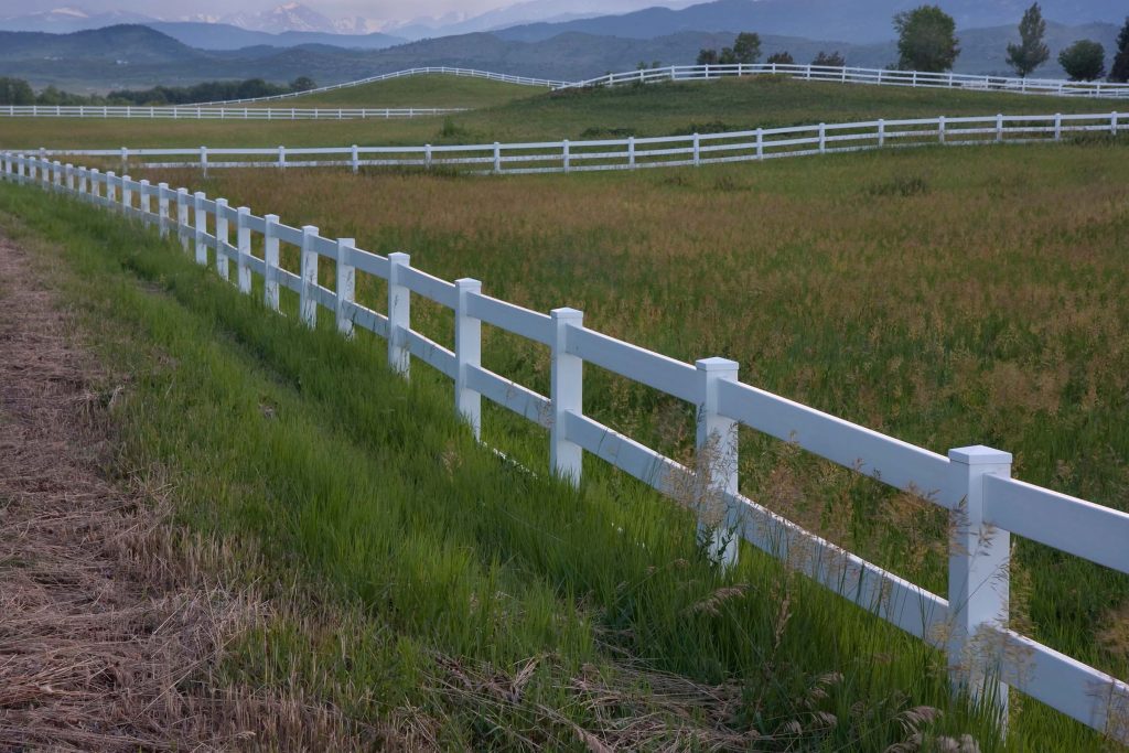 white fence around grass field in Colorado white fence around grass field in Colorado